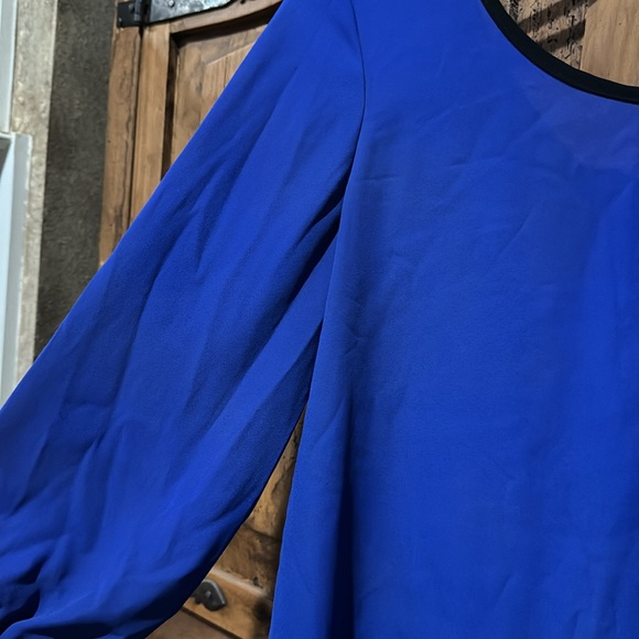 Sheer bright blue top with black bows on back. It’s a large by Agaci. - Picture 2 of 5